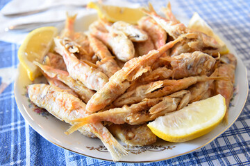 Fried Anchovies in the Plate With lemons