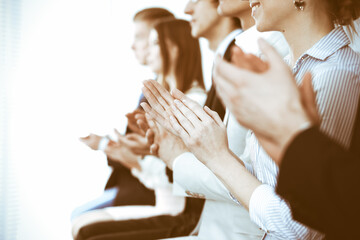 Business people clapping and applause at meeting or conference, close-up of hands. Group of unknown...
