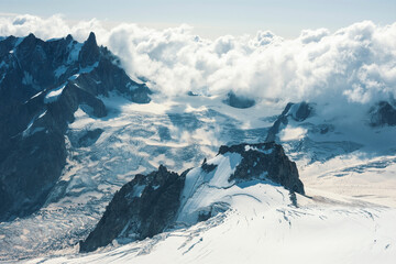 Beautiful blue morning landscape with clouds over alps in Mont Blanc massif from Aiguille du Midi 3842m, Chamonix, France