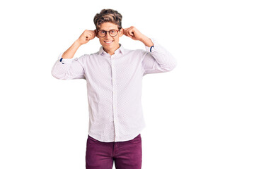 Young handsome man wearing business clothes and glasses smiling pulling ears with fingers, funny...