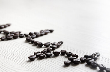 on a light wooden background lines of the heart electrocardiogram. heart rate is laid out from coffee beans