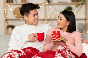 Asian Spouses Drinking Coffee Celebrating Christmas Eve Together At Home