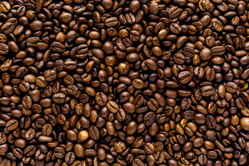 Fresh roasted coffee bean background. Background of roasted coffee beans, top view
