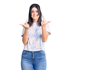 Obraz na płótnie Canvas Young beautiful girl wearing casual t shirt showing middle finger doing fuck you bad expression, provocation and rude attitude. screaming excited