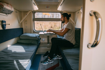 Man with laptop on the train.