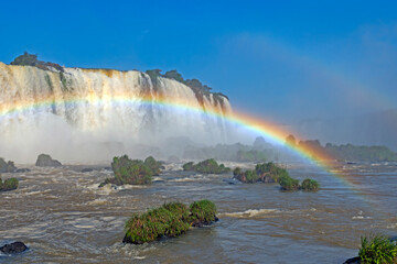 Rainbow Spanning the Rapids Beneath the Falls