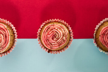Cupcakes on a two tone red and light blue background top view