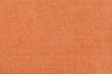 Texture of colorful canvas or burlap closeup, coral or peach color, modern background
