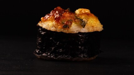 Close-up view of single baked sushi roll.