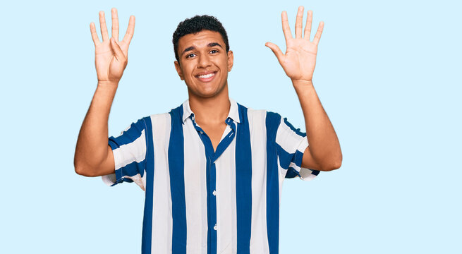 Young arab man wearing casual clothes showing and pointing up with fingers number nine while smiling confident and happy.