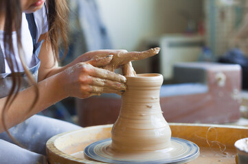 Girl potter at work at the beginning of her journey.