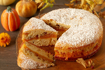 Homemade, rustic pumpkin cake on autumn decoration table