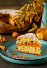 Homemade, rustic pumpkin cake on autumn decoration table