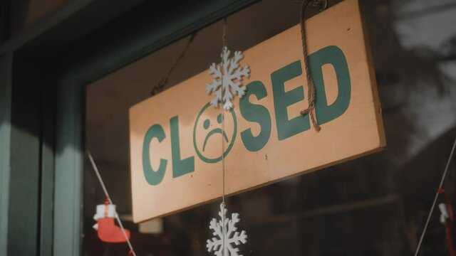 ign hanging on the door with the inscription closed with sad smile