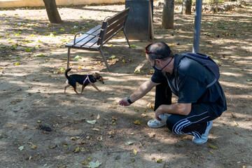 Unrecognized Man With Dog in the Park