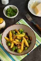 
Bavarian fried finger-shaped potato dumplings with green vegetables and mushrooms