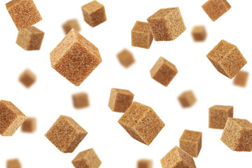 Falling Brown cane sugar cubes isolated on white background, selective focus