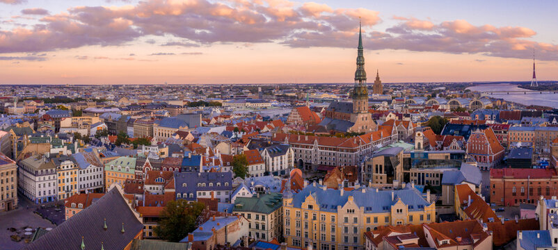 Sunrise over central Riga, Latvia. Aerial view of the St. Peter's Church. Close up panoramic view of the cathedral with Riga old town in the background.
