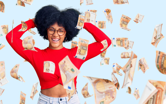 Young african american girl wearing casual clothes and glasses relaxing and stretching, arms and hands behind head and neck smiling happy