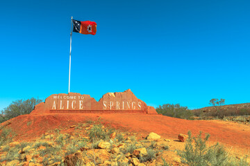 Alice Springs Welcome Sign and Australian Flag of Northern Territory in Central Australia. Tourism...