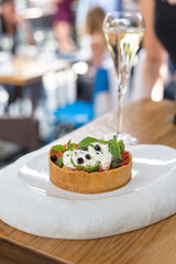 Fresh Tomato and Burrata Cheese Tart with Basil Leaves. Brunch in Restaurant