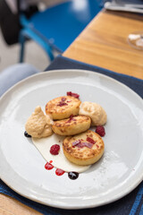Sweet Cottage Cheese Pancakes, Syrniki. Brunch in Restaurant