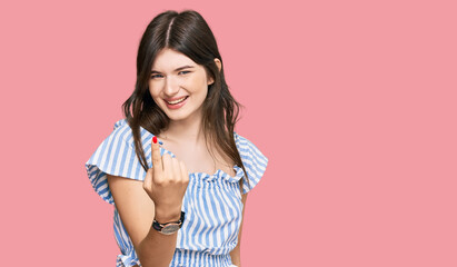 Obraz premium Young beautiful caucasian girl wearing casual clothes beckoning come here gesture with hand inviting welcoming happy and smiling