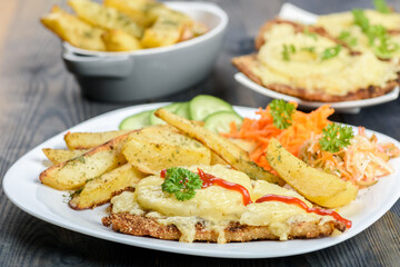 cutlet with pineapple and  baked potatoes with bouquet of salads