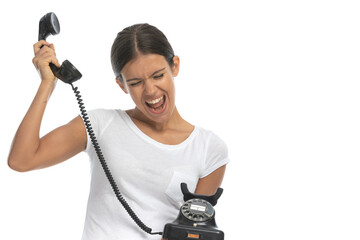 Cheerful casual woman talking on old telephone and shouting
