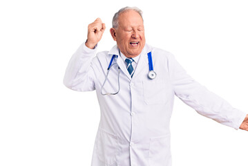 Senior handsome grey-haired man wearing doctor coat and stethoscope dancing happy and cheerful, smiling moving casual and confident listening to music