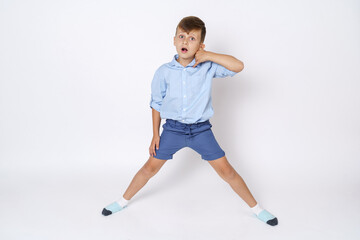 Obraz na płótnie Canvas A portrait of a boy who expresses emotions by portraying a conversation on the phone. Isolated on white background.