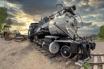Fototapeta na wymiar Old classic train engine in a railyard
