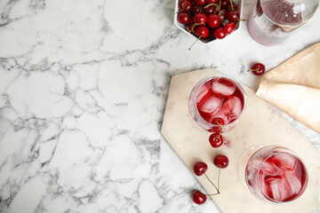 Delicious cherry wine with ripe juicy berries on white marble table, flat lay. Space for text