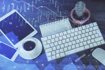 Double exposure of forex chart hologram over desktop with phone. Top view. Mobile trade platform concept.