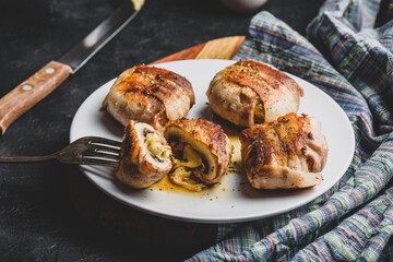 Bacon-wrapped button mushrooms stuffed with grated cheddar cheese and spices