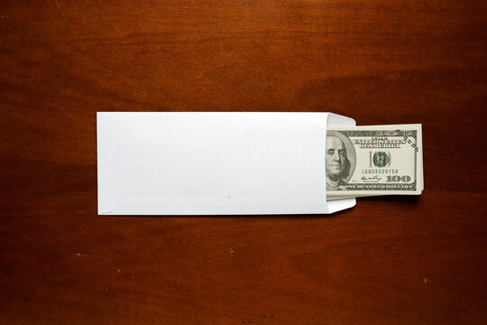 A picture of envelope fill with fake money for corruption and bribery. International Anti-Corruption Day concept