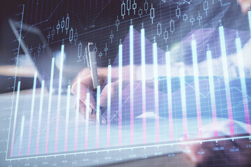 Double exposure of forex chart drawing over people taking notes background. Concept of financial analysis