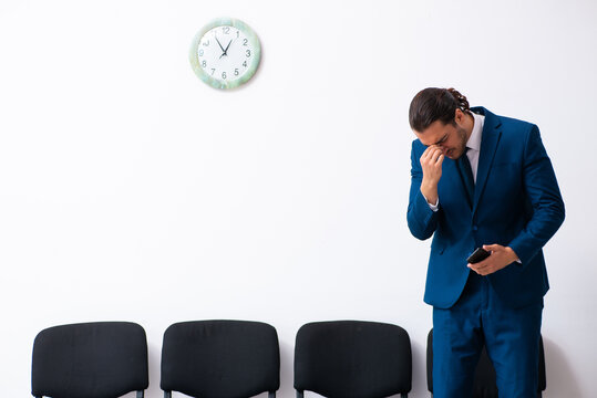 Young businessman waiting for an interview at hall