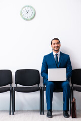 Young businessman waiting for an interview at hall