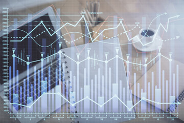 Double exposure of businesswoman hands typing on computer and forex chart hologram drawing. Financial analysis concept.