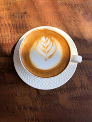 Hot cappuccino cup on wooden table