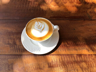 Hot cappuccino cup on wooden tabla