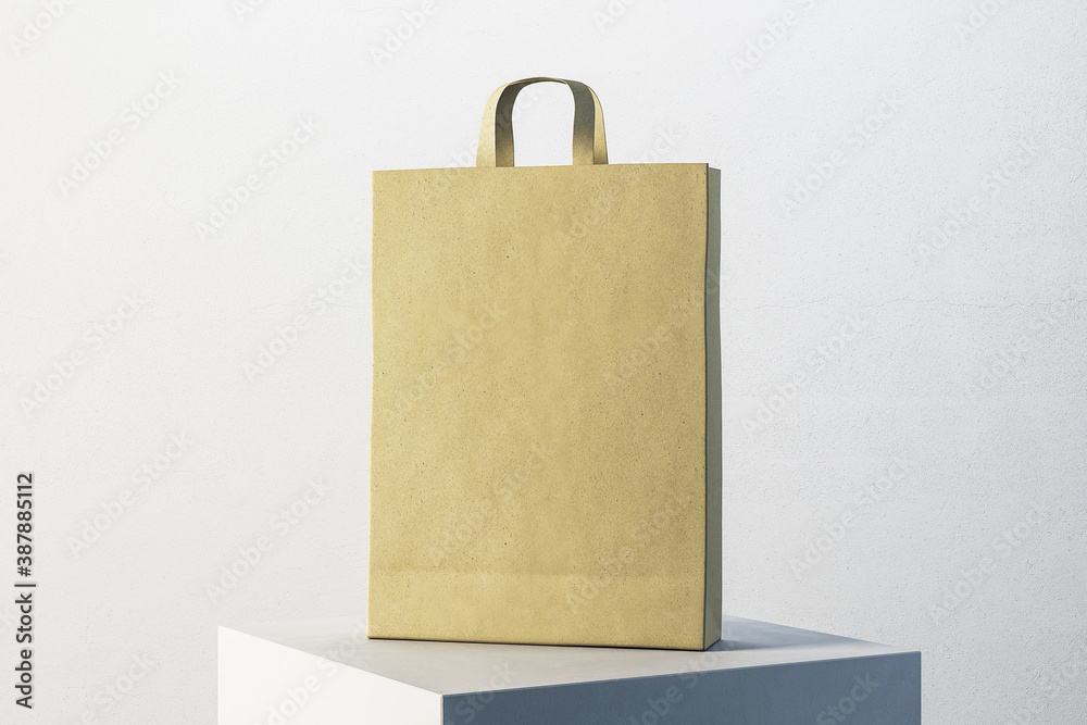 Poster paper shopping bag with handles on white cube.