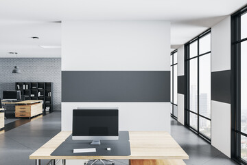 Modern office room with computers and blank wal