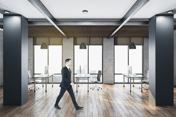 Fototapeta na wymiar Businessman walking contemporary office room