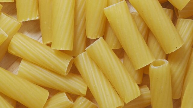 Close-up of raw penne pasta, texture or background, italian design.