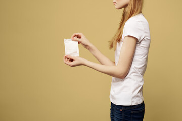 Woman with pad in hand on beige background cropped side view