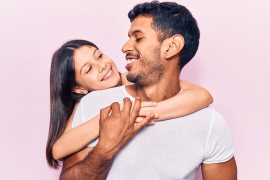 Hispanic Young Family Of Father And Daughter Hugging Together With Love