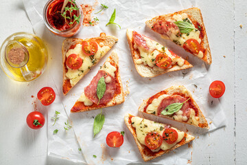 Unhealthy Toast with cheese, salami and basil