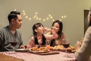 Asian young little girl enjoying her meal with crispy fried chicken.